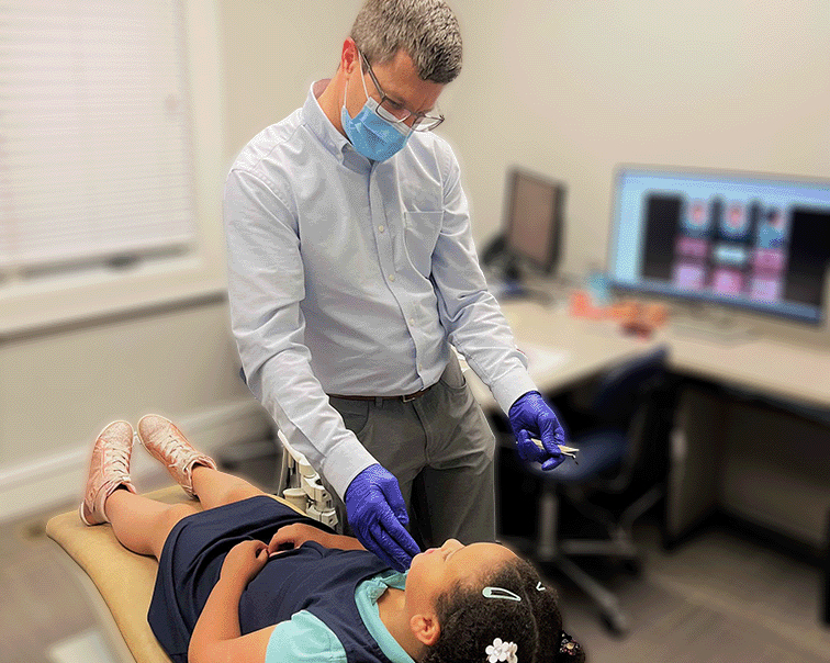 Dr Herring with patient on operating table